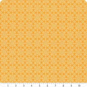 Gold cotton quilting fabric with small repeating medallion pattern