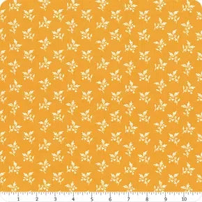 Orange quilting fabric yardage with small white sprig motifs