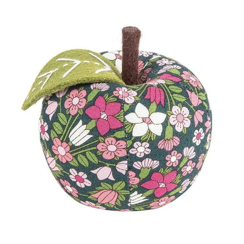 Navy floral apple-shaped pin cushion with vertical brown stem.
