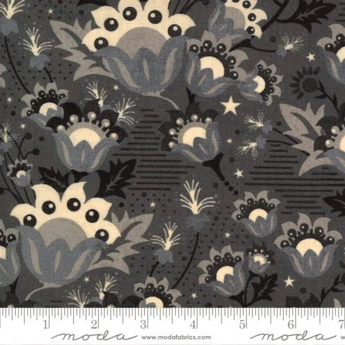 Moon-themed fabric with dark gray background, cream moons, stars, and leafy silhouettes