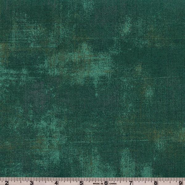 Dark jade textured fabric yardage with grunge pattern, visible woven texture