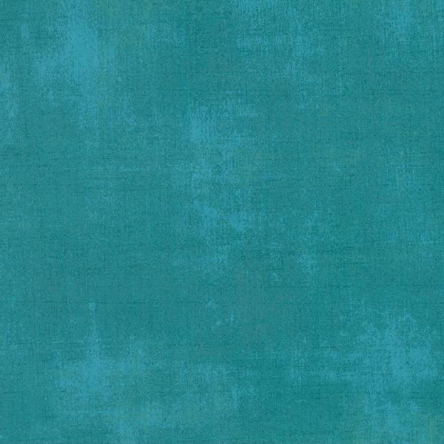 Textured fabric in ocean teal with mottled grunge pattern