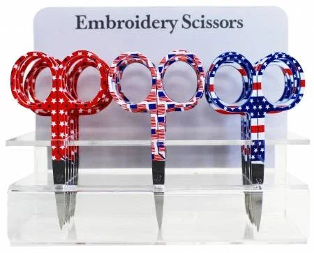 Clear plastic display holding embroidery scissors with stars-and-stripes handles