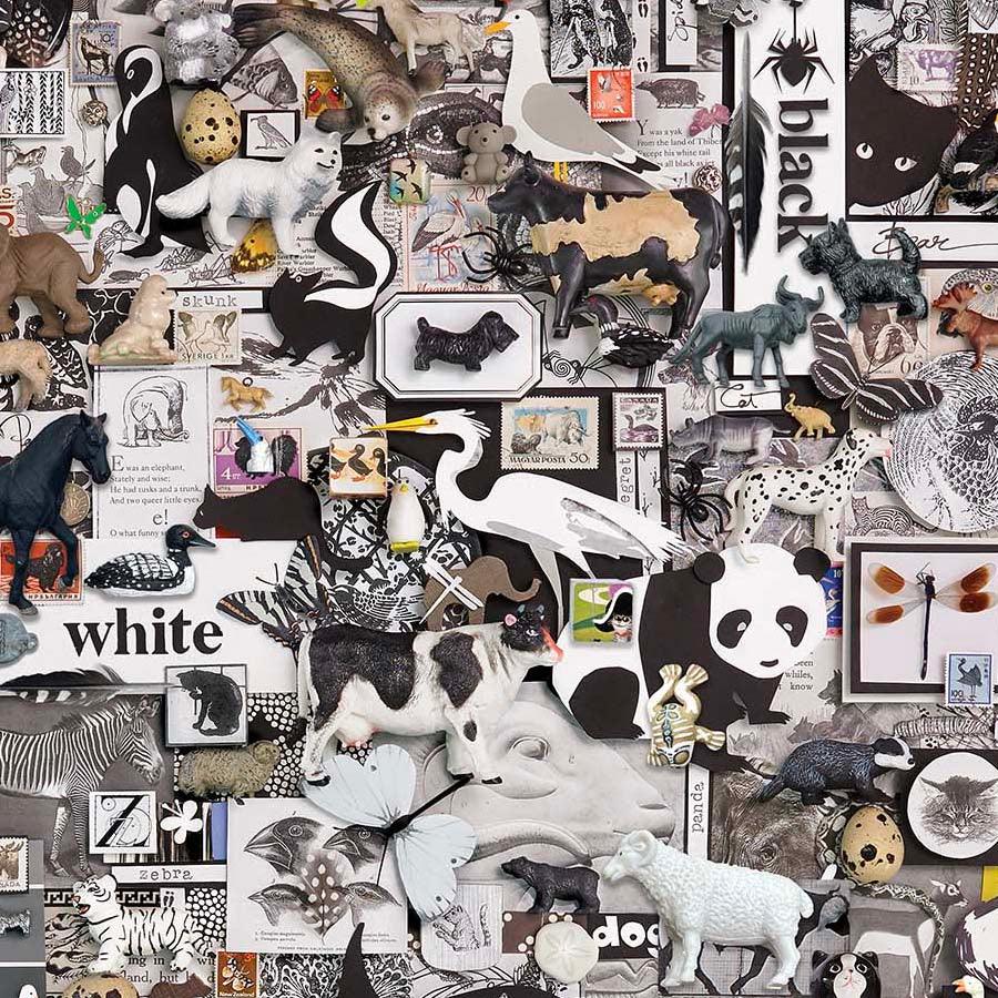 Animal collage fabric in black, white, and small accent colors with zoo-style prints