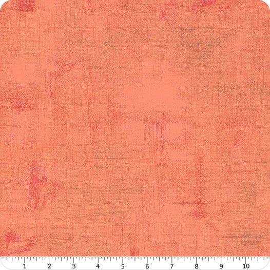 Orange textured fabric yardage with subtle mottled finish