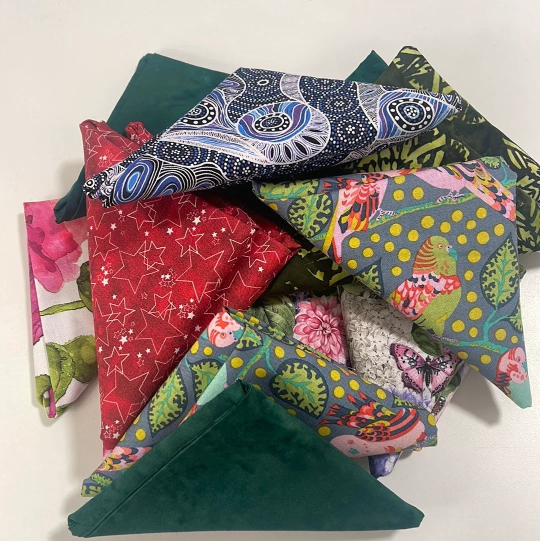 Cotton fabric fat quarter bundle with red, teal, navy, and patterned prints