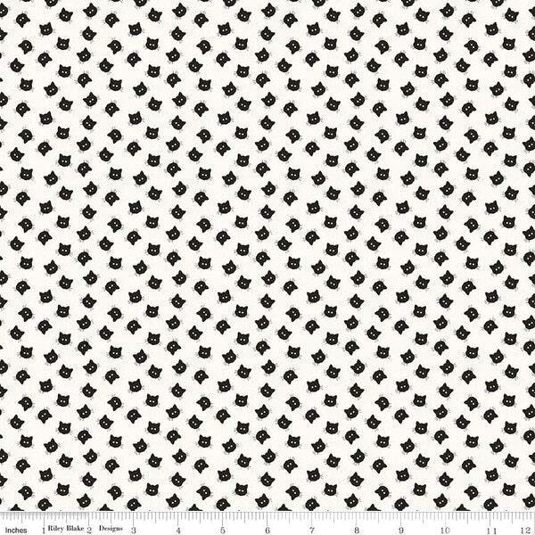 White cotton fabric with repeating black cat faces pattern