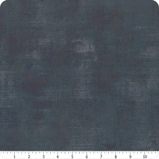 Textured dark blue fabric swatch with subtle mottled pattern