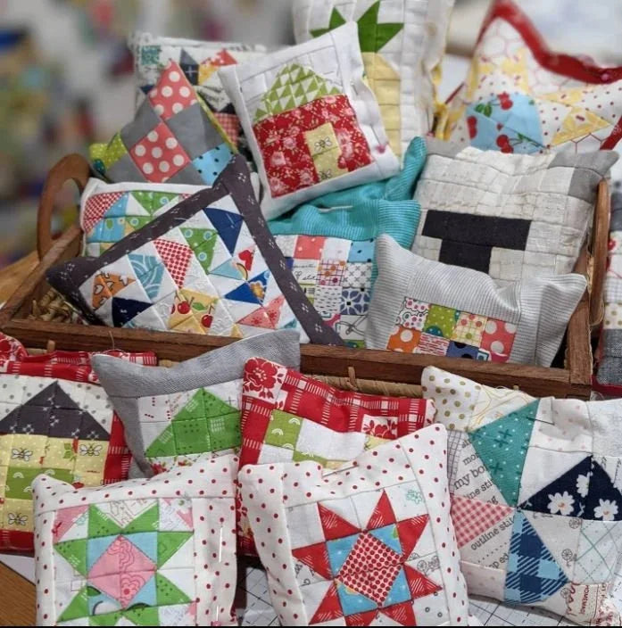 Assorted patchwork fabric pincushions with colorful star and square blocks