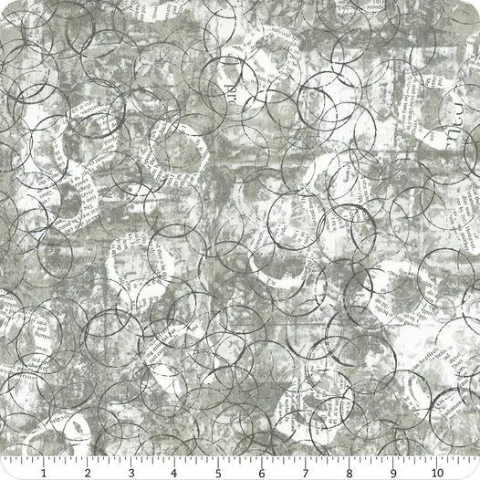 Light gray printed fabric with overlapping circular line drawings and small text-like marks