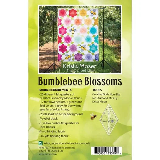 Quilt kit box front with multicolor floral geometric blocks and honeycomb motifs