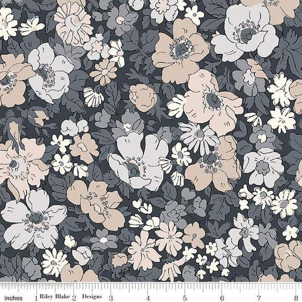 Floral fabric yardage with dark navy background, cream and peach blossoms with gray centers