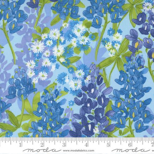 Floral quilting cotton fabric with blue and green blossoms on light background