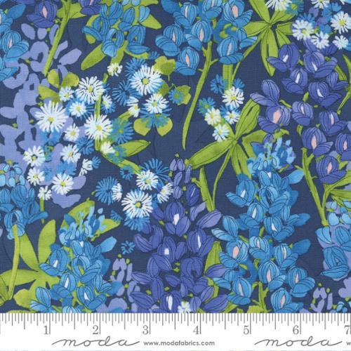 Floral cotton fabric with navy blue ground, blue and white daisies, green leaves