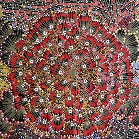 Printed fabric with red, black, and multicolor scattered floral and leaf pattern