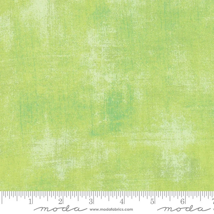 Grunge fabric in key lime green with distressed, mottled texture.