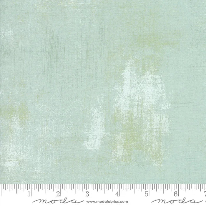 Grunge mint fabric swatch, distressed texture, shown with ruler scale