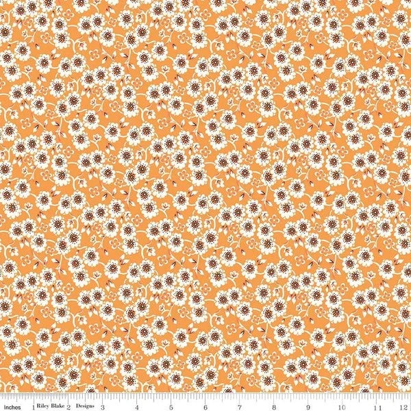 Orange quilting fabric with small white and brown daisy flowers