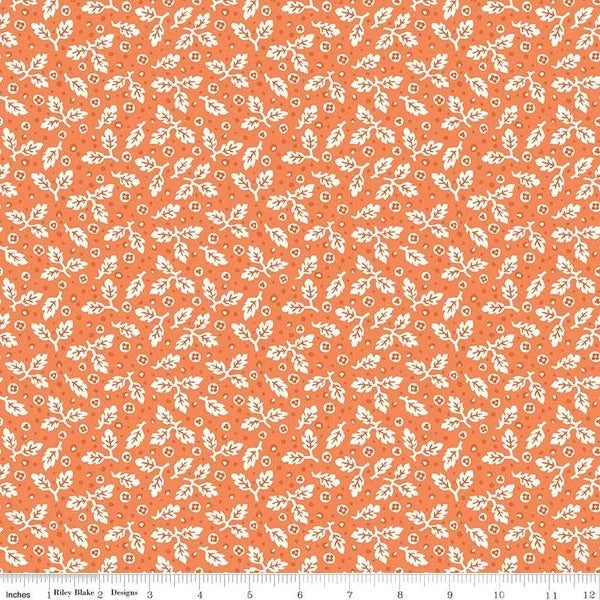 Printed quilting fabric, orange with small white leaf and pumpkin motif
