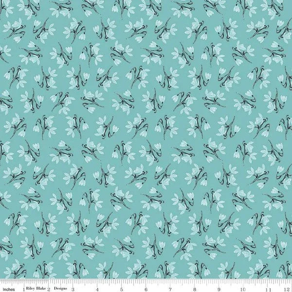 Light blue quilting fabric with repeating peacock stem floral motif