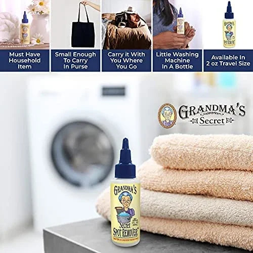 Spot remover bottle with dark blue dropper cap standing beside folded towels