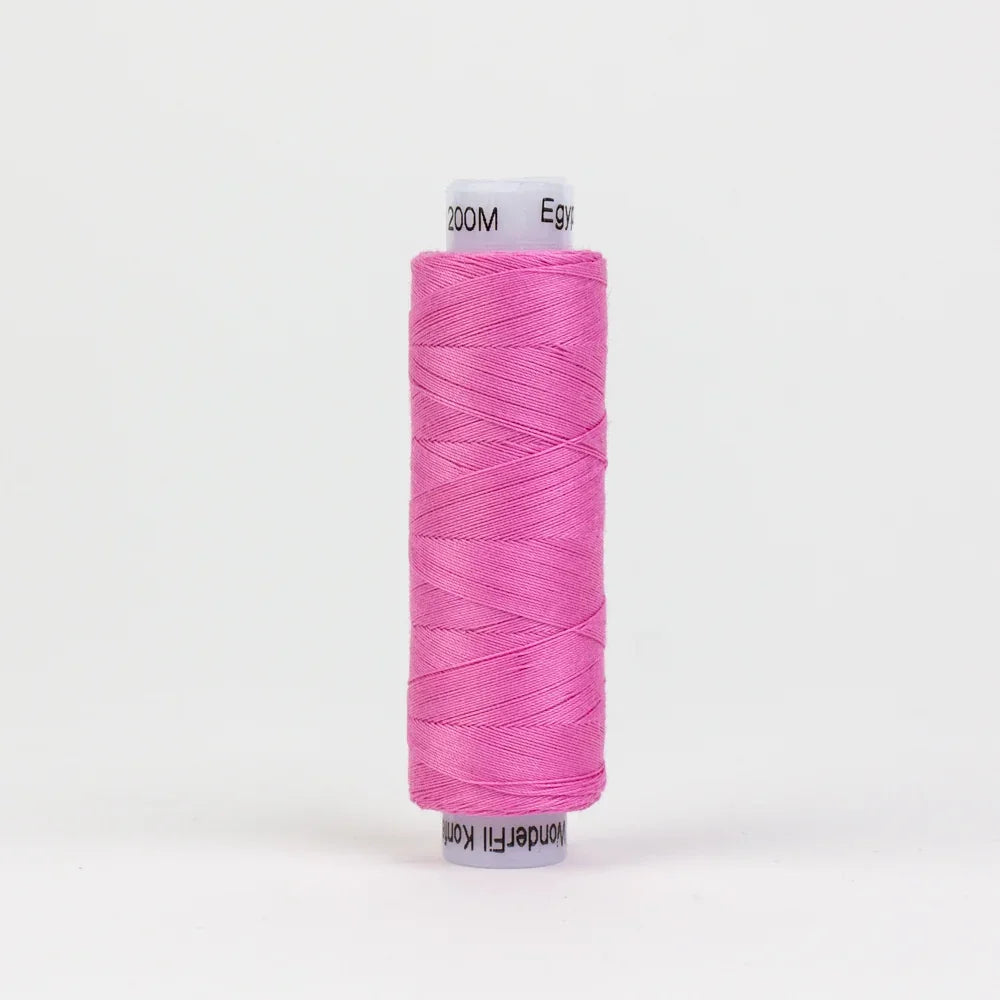 Pink sewing thread spool, long strand wound on bobbin