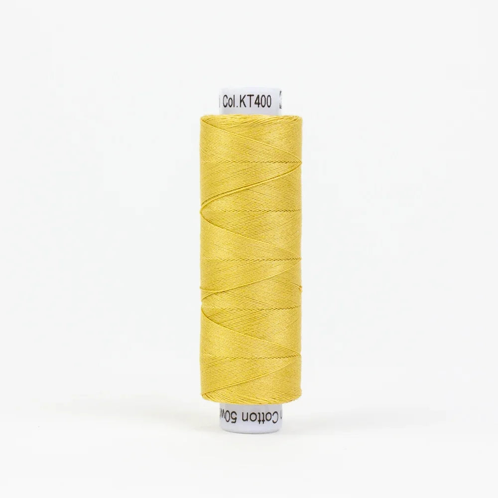 Gold thread spool with wound strand, small label on top