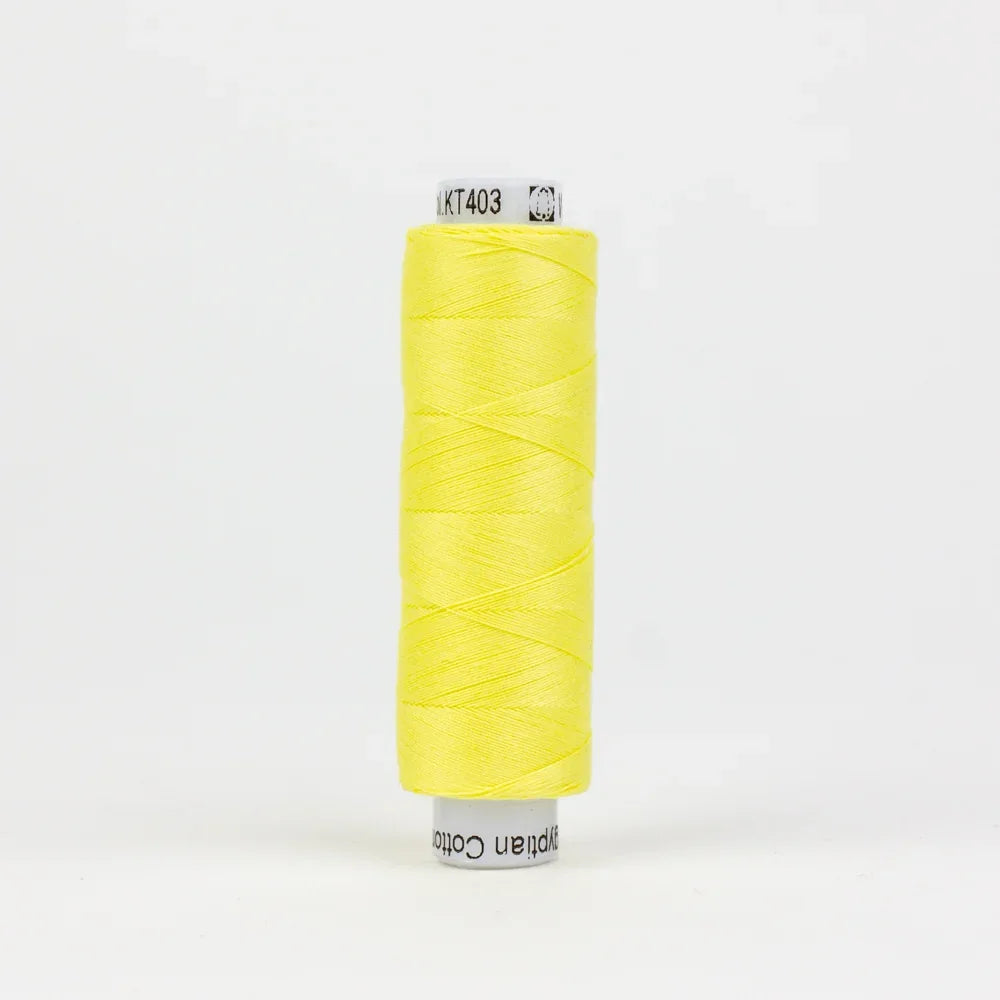 Yellow sewing thread spool, tightly wound on a plastic core