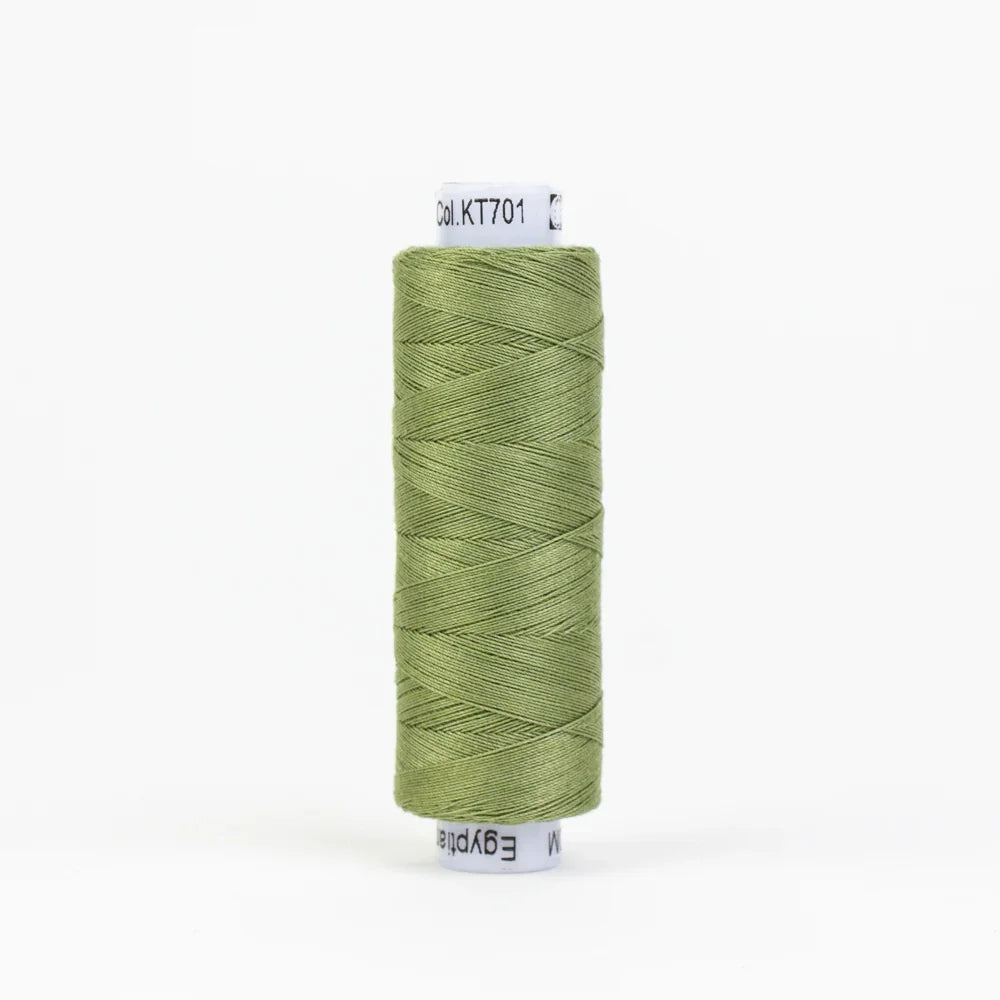 Sage green sewing thread spool with wound yarn