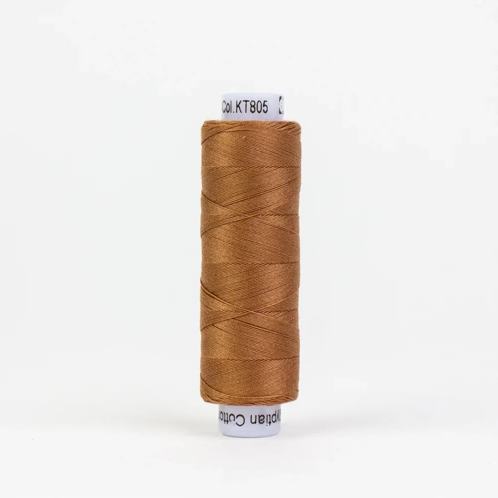 Rust-brown thread spool, tightly wound on a white label base