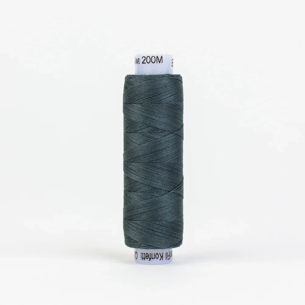 Blue-grey sewing thread spool on a white cardboard core