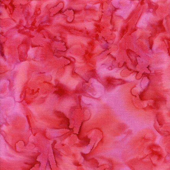 Batik fabric close-up with pink and red floral pattern