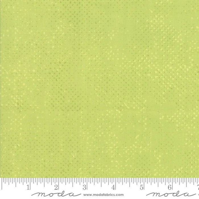 Pistachio green fabric swatch with scattered tiny white dots
