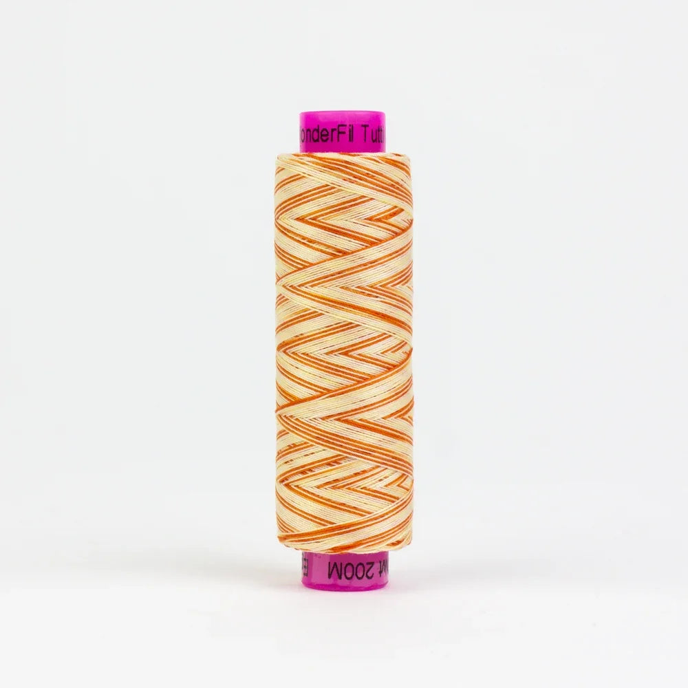 Yarn spool with orange and cream zigzag stripe wrap