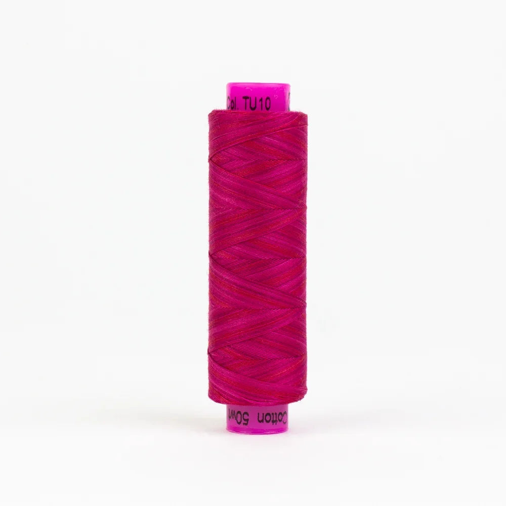 Tutti Roses spool of magenta sewing thread with wound strands