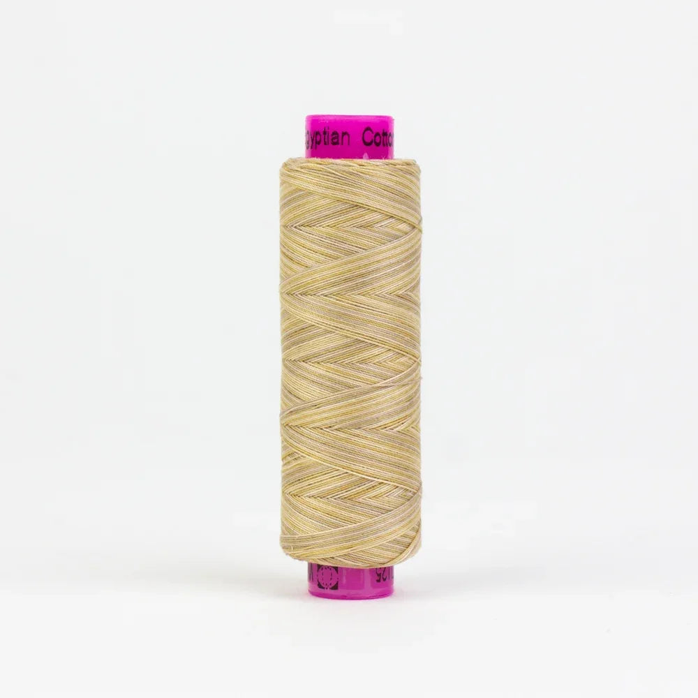 Beige yarn spool, twisted thread with bright purple cap and label band