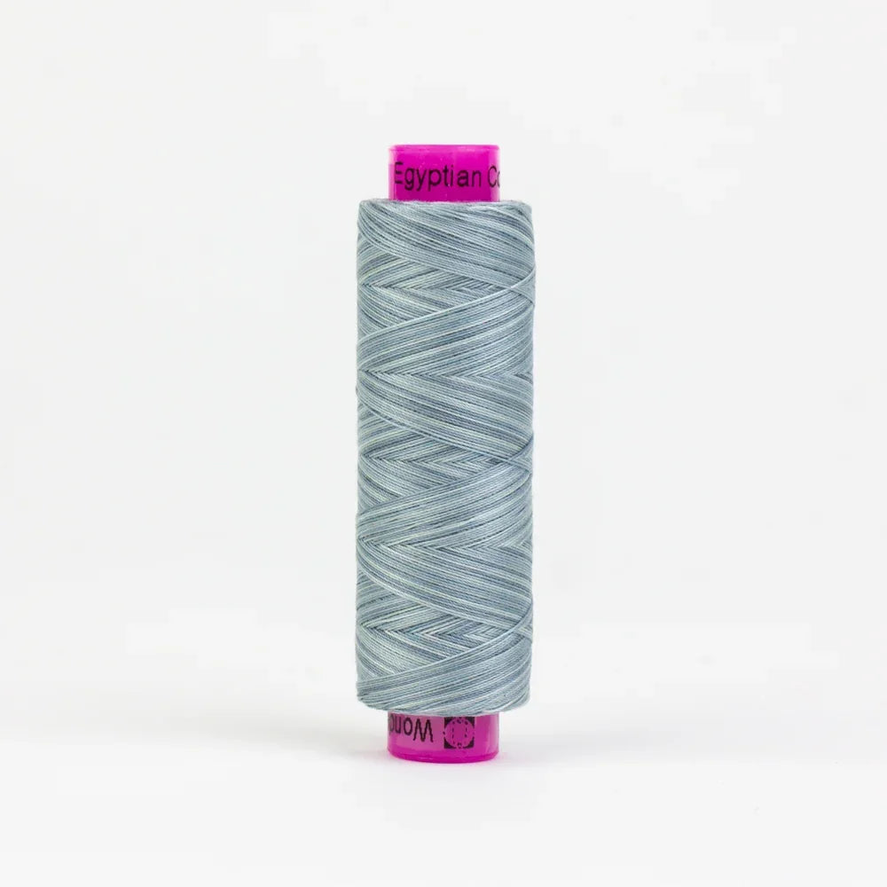 Sage green yarn spool with purple top and bottom labels