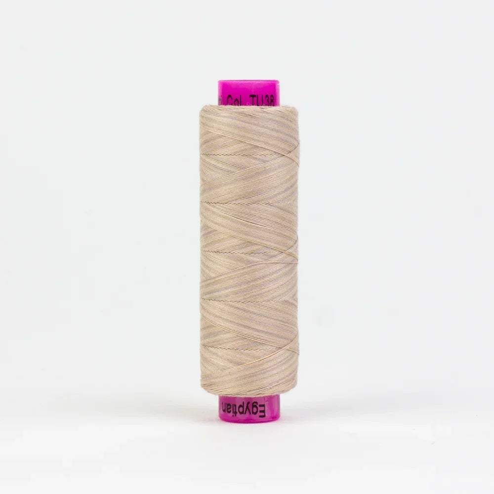 Beige jute yarn spool with tightly wound thread