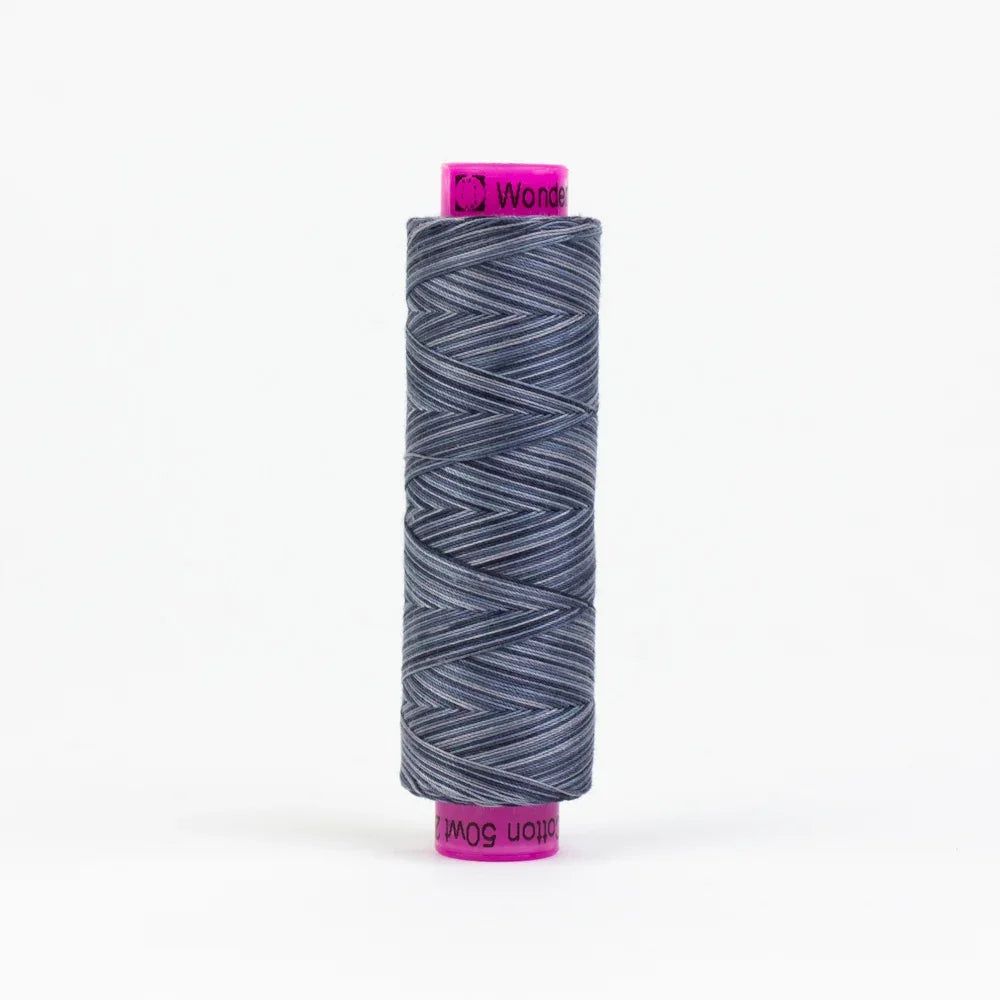 Spool of slate-blue yarn thread, tightly wound on a white label