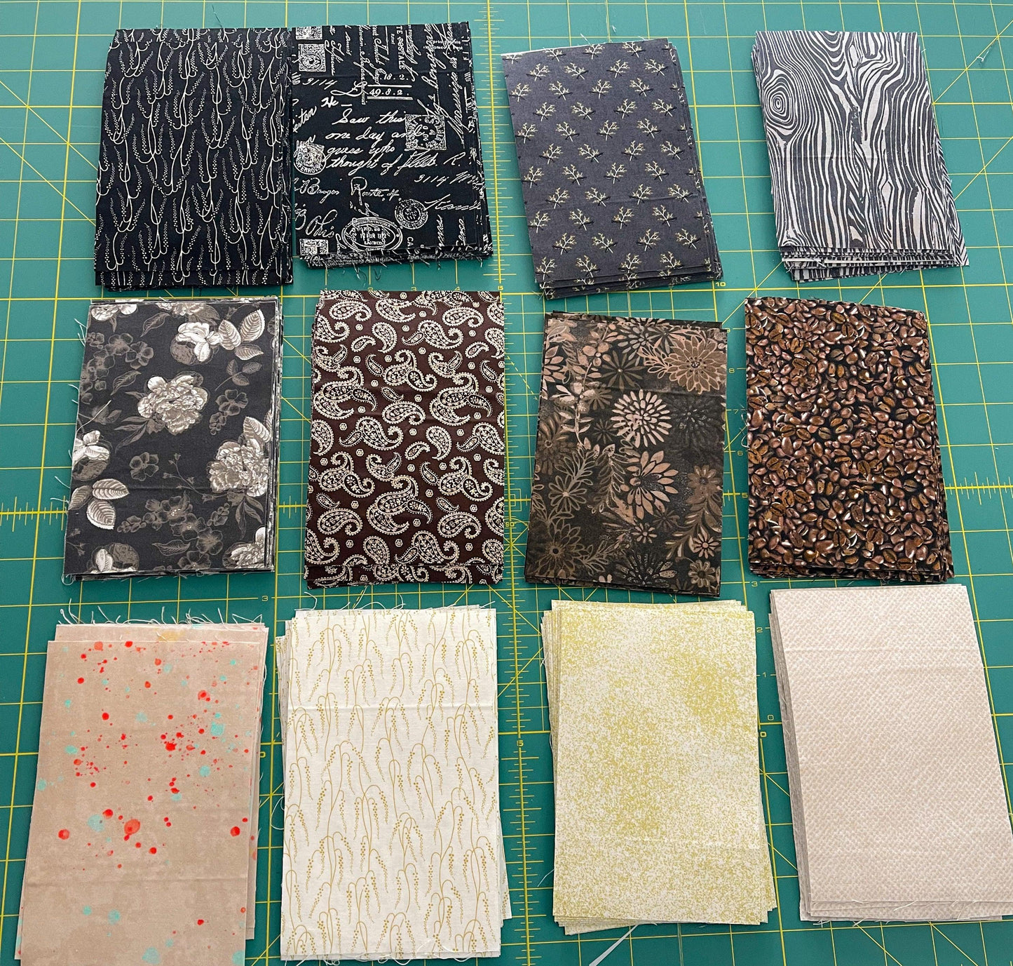 Fabric swatch packet with 8 printed squares in black, brown, and cream colors