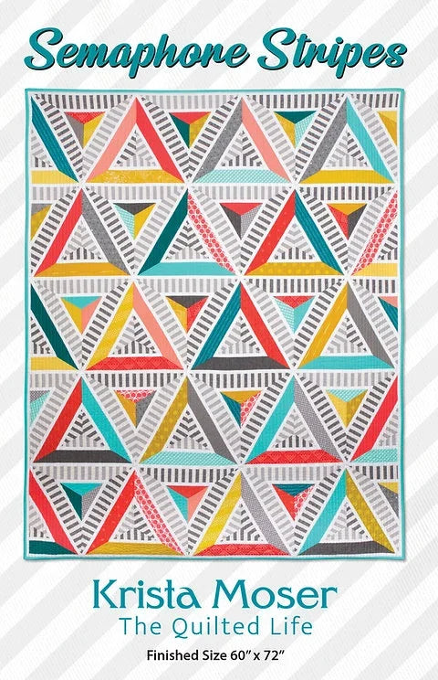 Quilt pattern cover with colorful triangle stripe blocks in teal, coral, yellow, and white