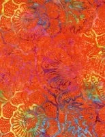 Batik fabric with tropical floral and leaf patterns in red, orange, and teal
