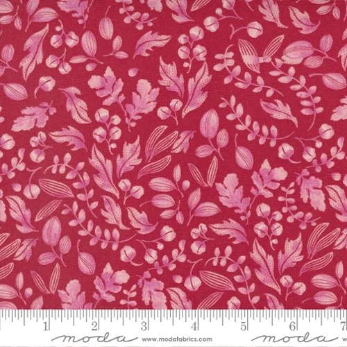 Pink floral cotton fabric with scattered leaf and blossom motifs
