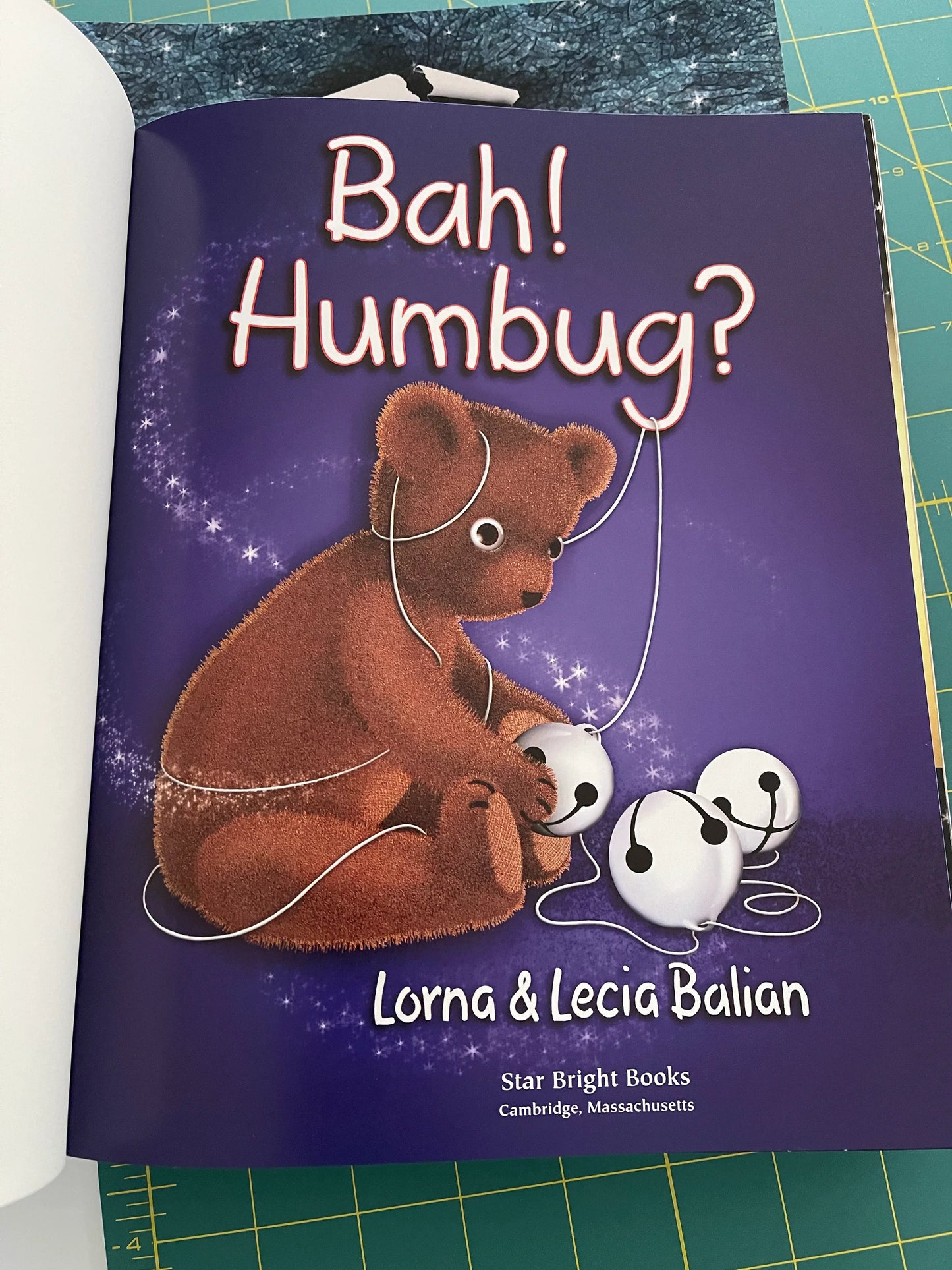 Children's book cover, brown bear holding microphone under Bah! Humbug? title