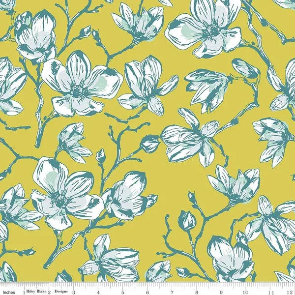 Floral cotton fabric with white magnolia blossoms on yellow background