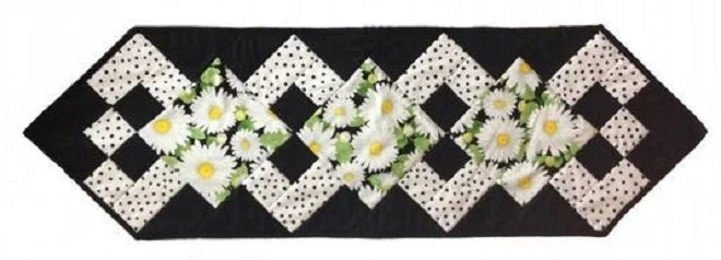 Quilt block layout for table runner with black-and-white checker squares and white daisies
