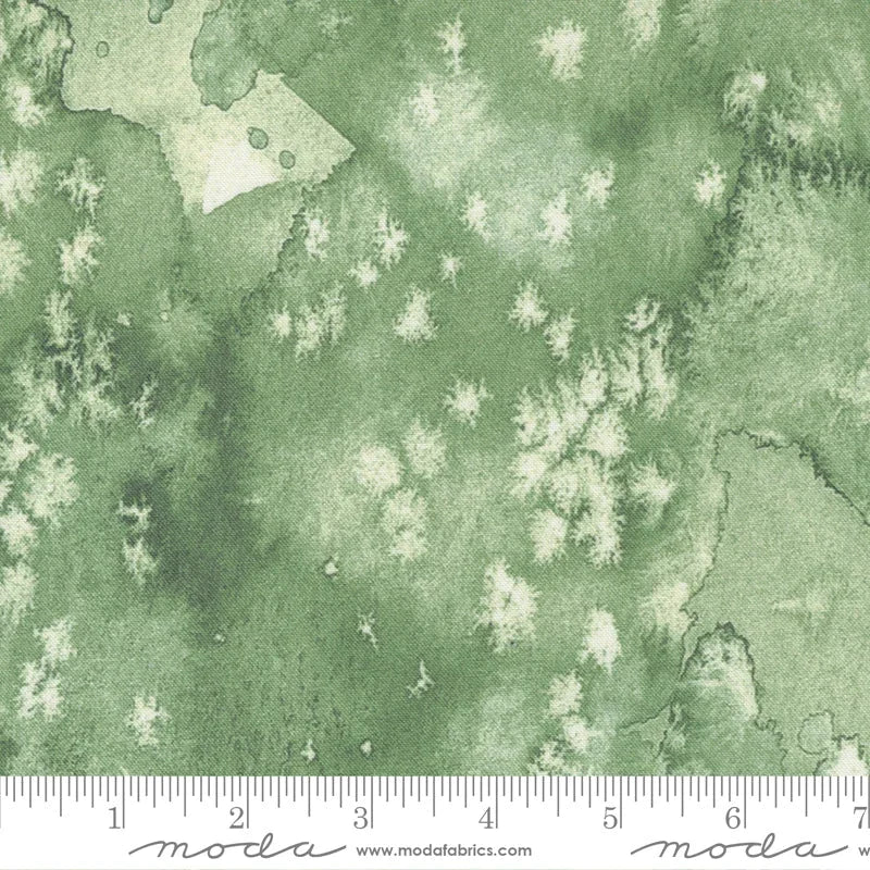 Green fabric with scattered white bird and leaf motifs, quilt-weight yardage