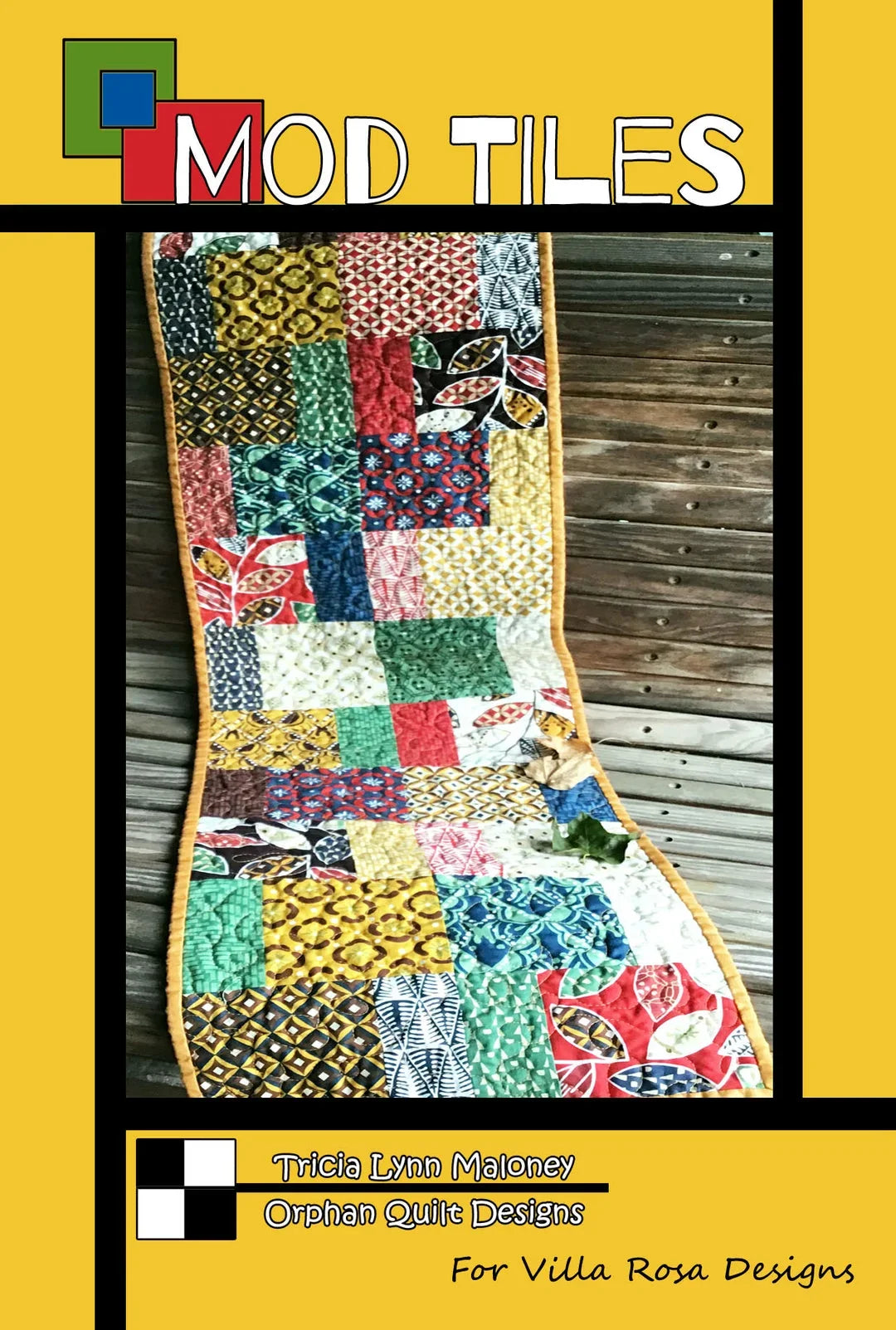 Multicolor patchwork table runner quilt with geometric tile squares and borders