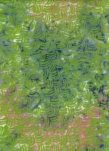 Batik fabric with repeating celestial blossom motifs in green, blue, and purple swirls