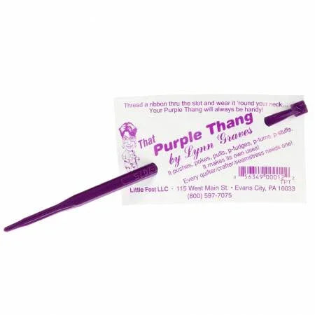 Purple threading tool with curved hook tip on card backing